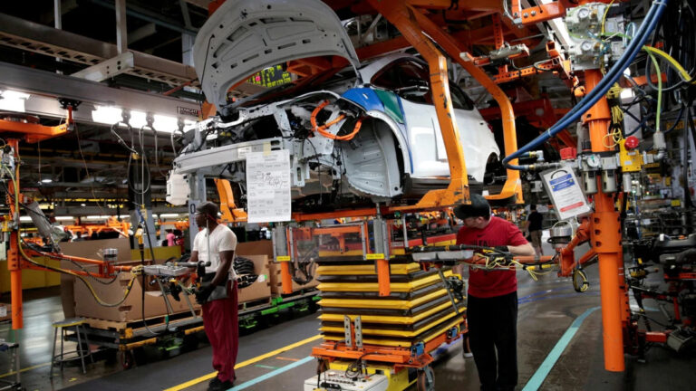 file photo general motors assembly workers connect a battery pack underneath a partially assembled 2018 chevrolet bolt ev vehicle on the assembly line at orion assembly in lake orion