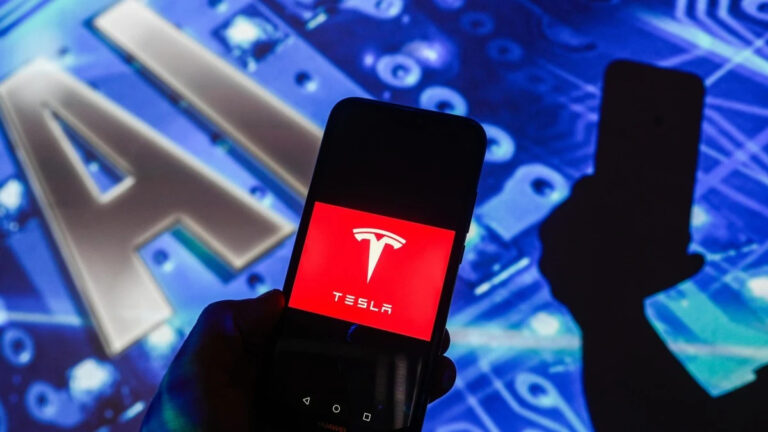 in this photo illustration a tesla logo is displayed on a