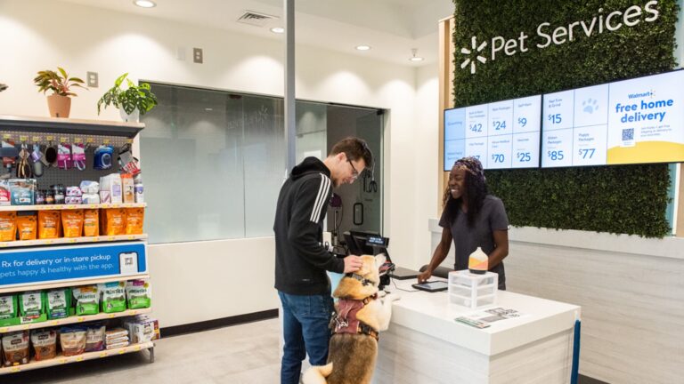 108044323 1728328206883 walmart pet services staff greets customer with dog