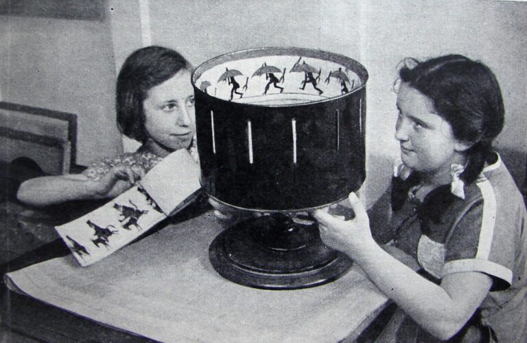 Two girls playing with zoetrope